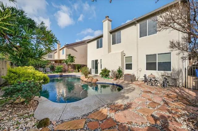a view of a patio with couches table and chairs and potted plants