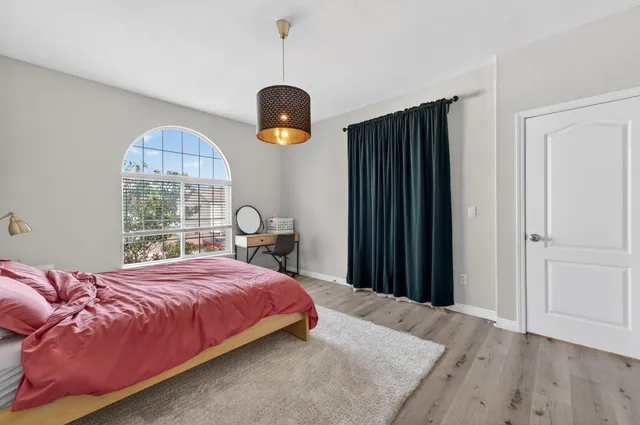 a bedroom with a bed and a window