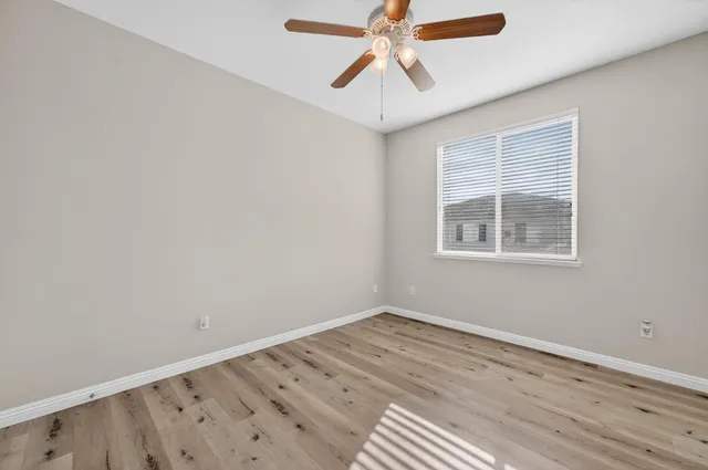 a view of a room with wooden floor and windows