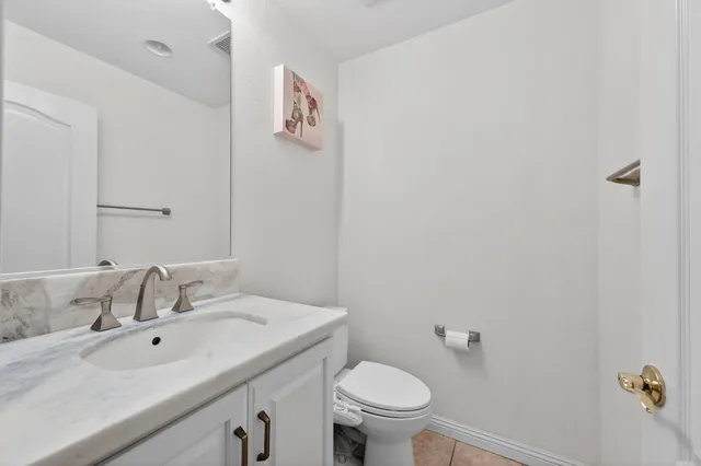 a bathroom with a sink and mirror with toilet