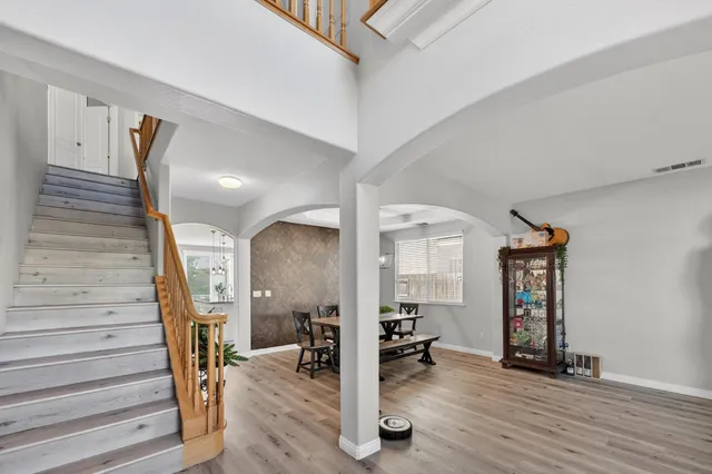 a view of a hallway with wooden floor and windows