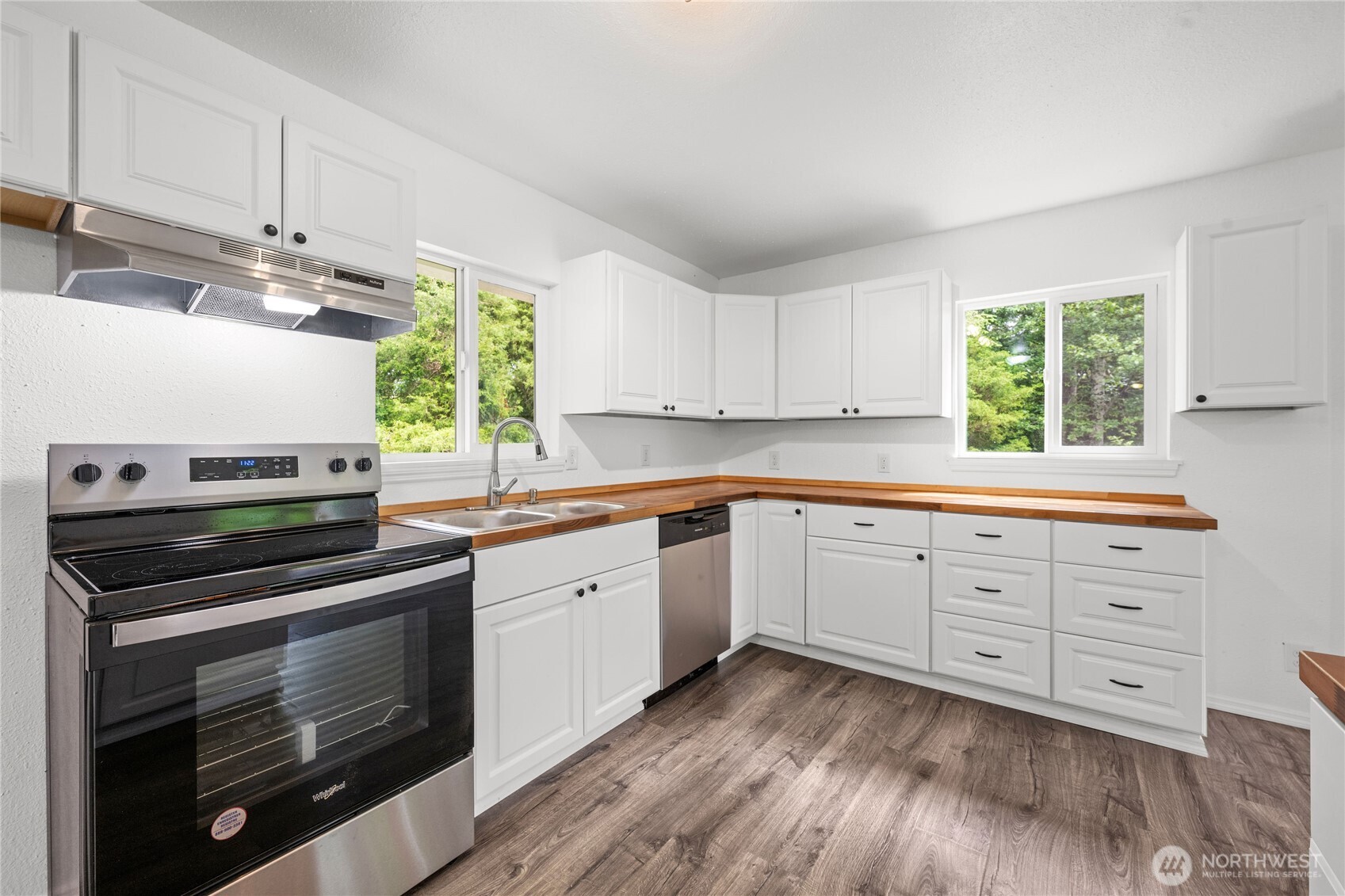 2693 Highway 101 Long Beach, WA 98631 - Photo 12 of 31 a kitchen with granite countertop cabinets stainless steel appliances and a window