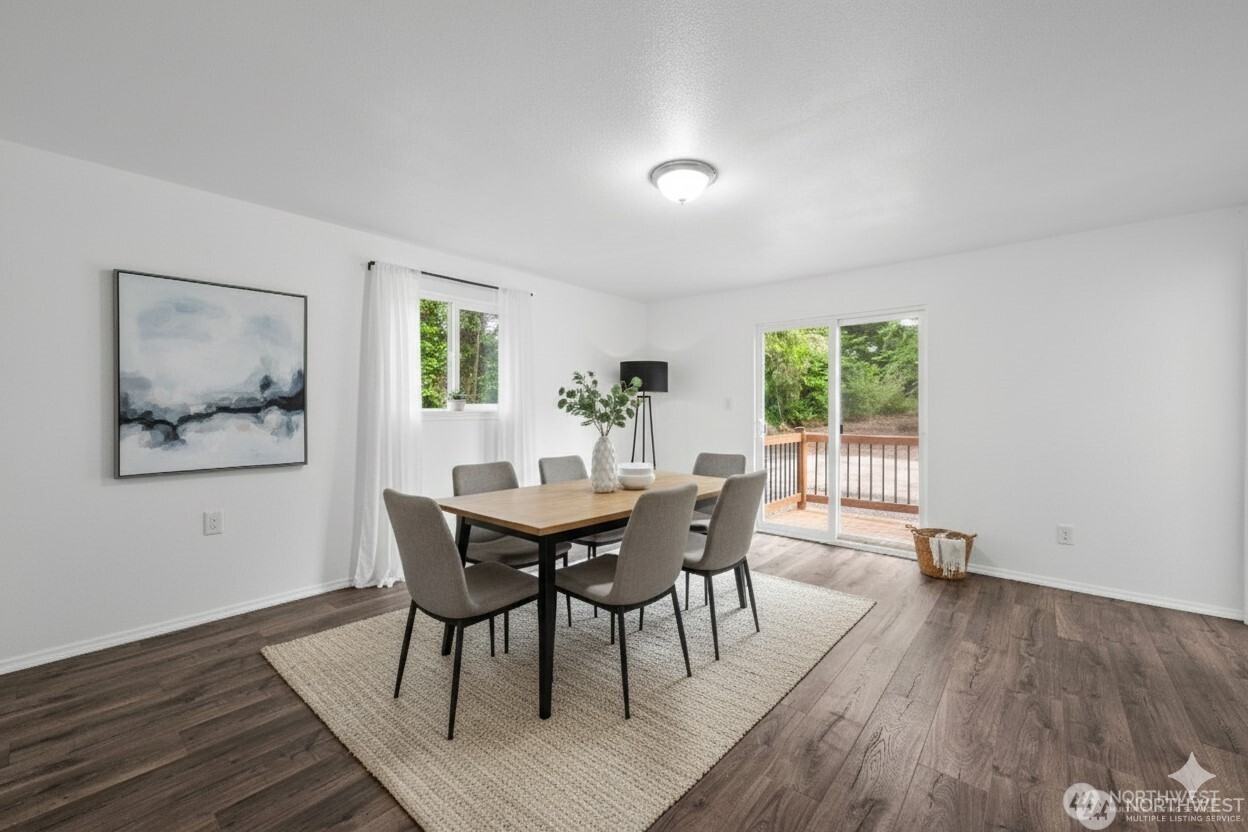 2693 Highway 101 Long Beach, WA 98631 - Photo 14 of 31 a view of a dining room with furniture window and wooden floor