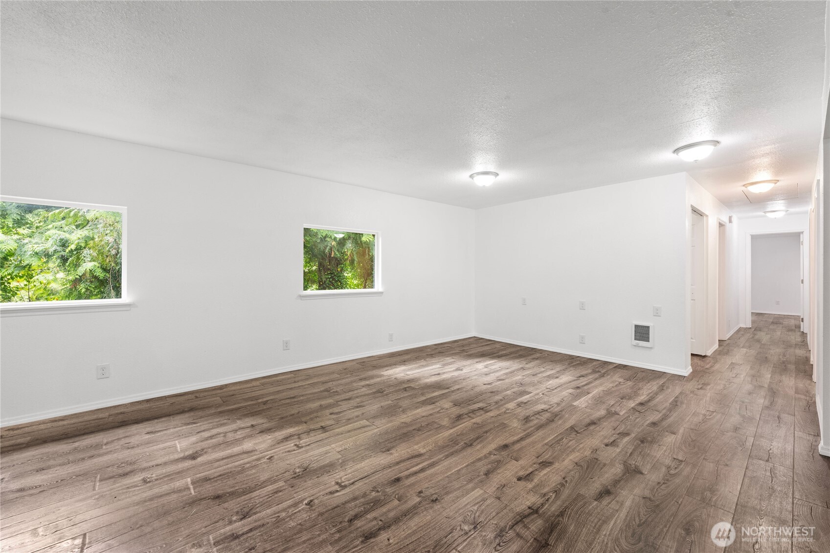 2693 Highway 101 Long Beach, WA 98631 - Photo 16 of 31 an empty room with wooden floor and windows