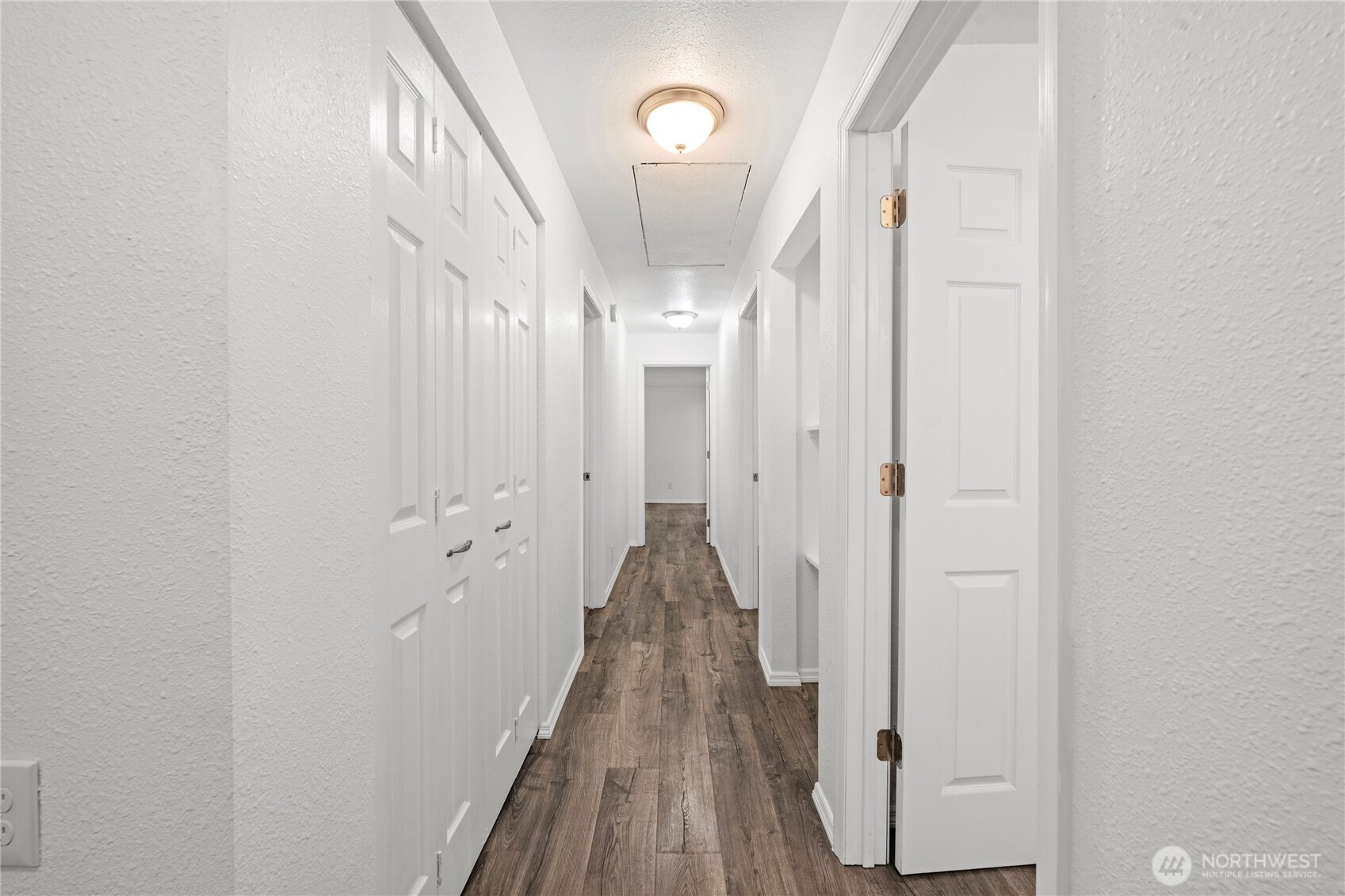 2693 Highway 101 Long Beach, WA 98631 - Photo 17 of 31 a view of a hallway with wooden floor and staircase