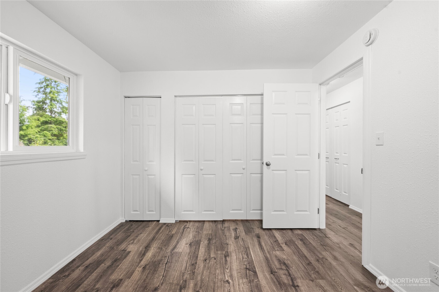 2693 Highway 101 Long Beach, WA 98631 - Photo 20 of 31 a view of an empty room with wooden floor and a window