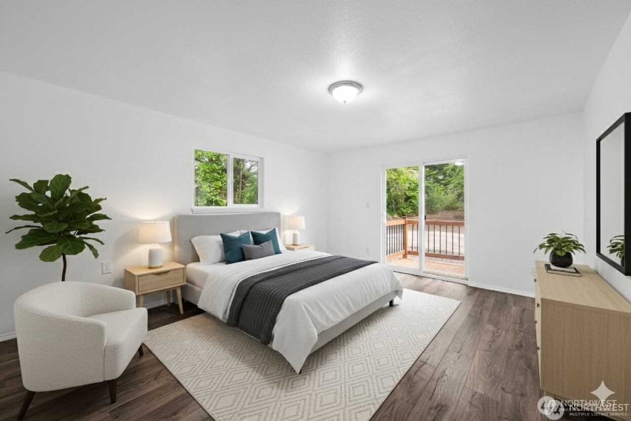 2693 Highway 101 Long Beach, WA 98631 - Photo 24 of 31 a bedroom with a large bed and a potted plant
