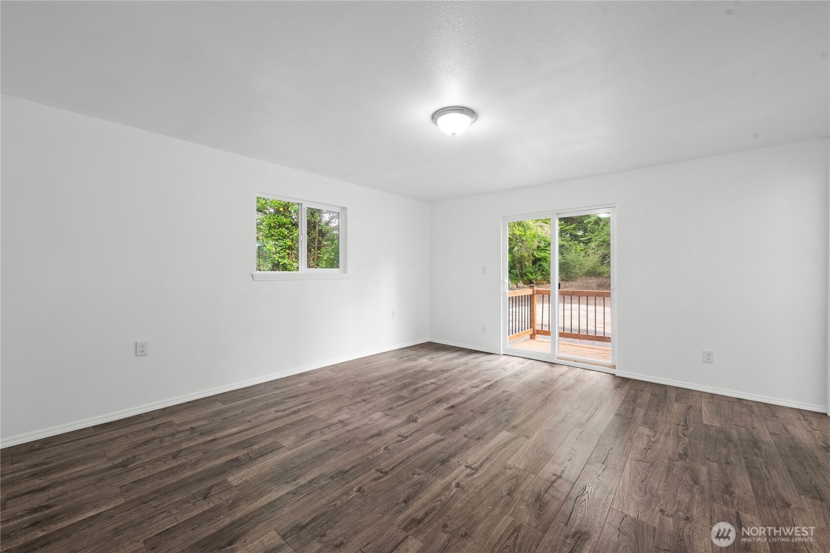 2693 Highway 101 Long Beach, WA 98631 - Photo 25 of 31 a view of an empty room with wooden floor and a window
