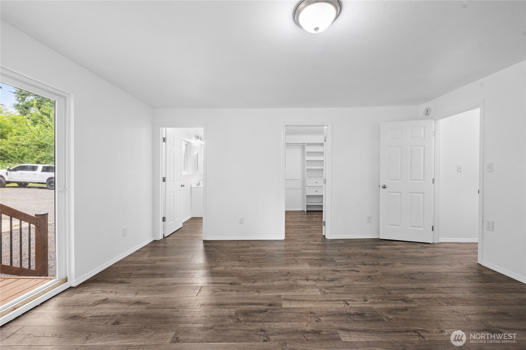 2693 Highway 101 Long Beach, WA 98631 - Photo 26 of 31 a view of an empty room with wooden floor and windows
