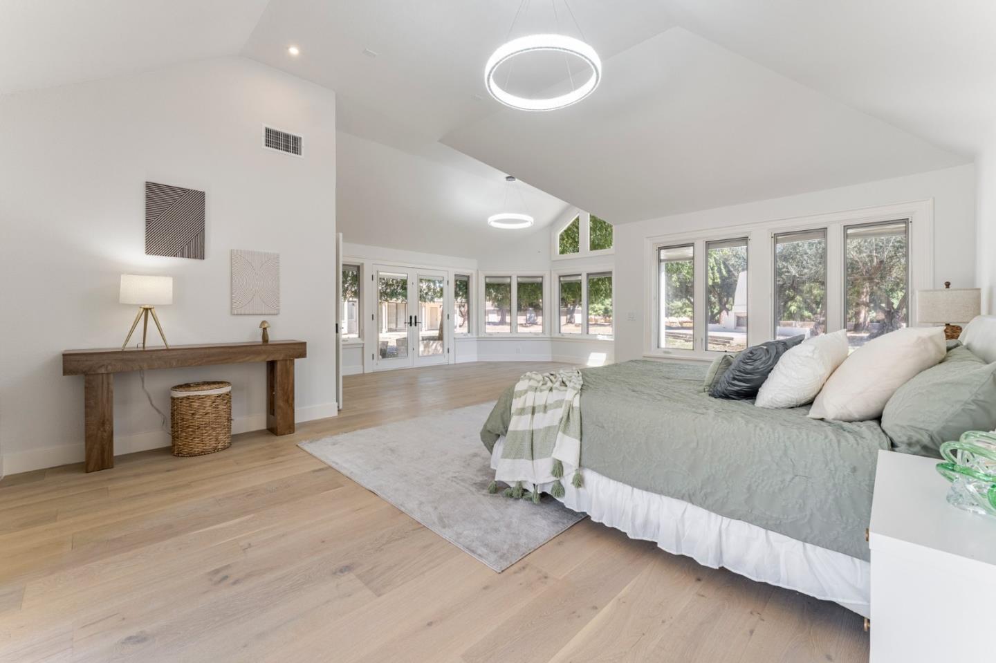 1080 Finley Road Pleasanton, CA 94588 - Photo 15 of 85 a bedroom with a large bed and a chandelier