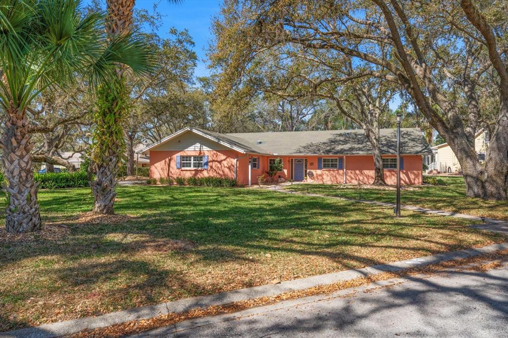 1921 Cardinal Road Dunedin, FL 34698 - Photo 44 of 52 a front view of a house with a yard