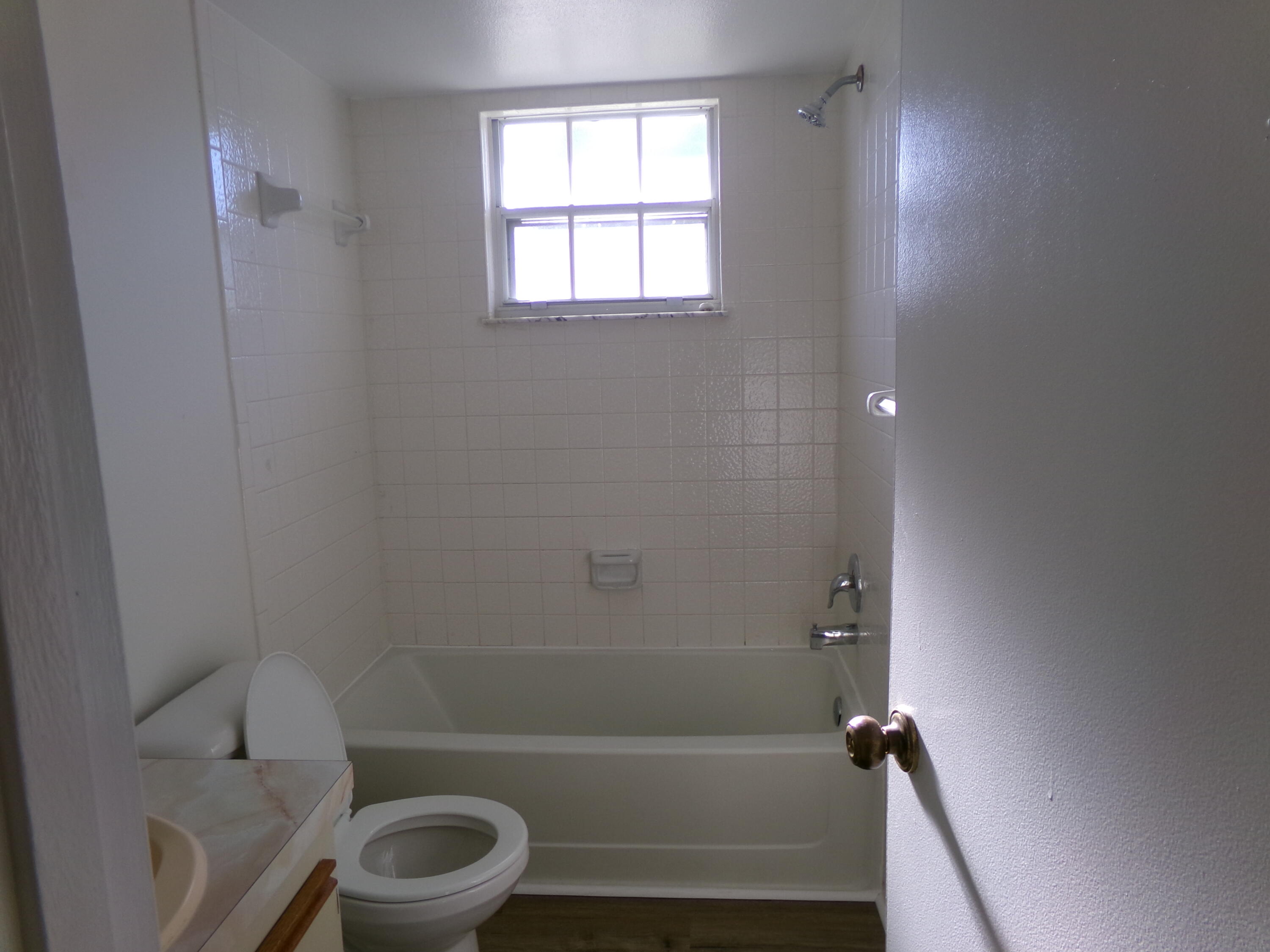 1514 Southeast Royal Green Circle, Unit I203 Port St. Lucie, FL 34952 - Photo 12 of 13 a bathroom with a toilet and a bath tub
