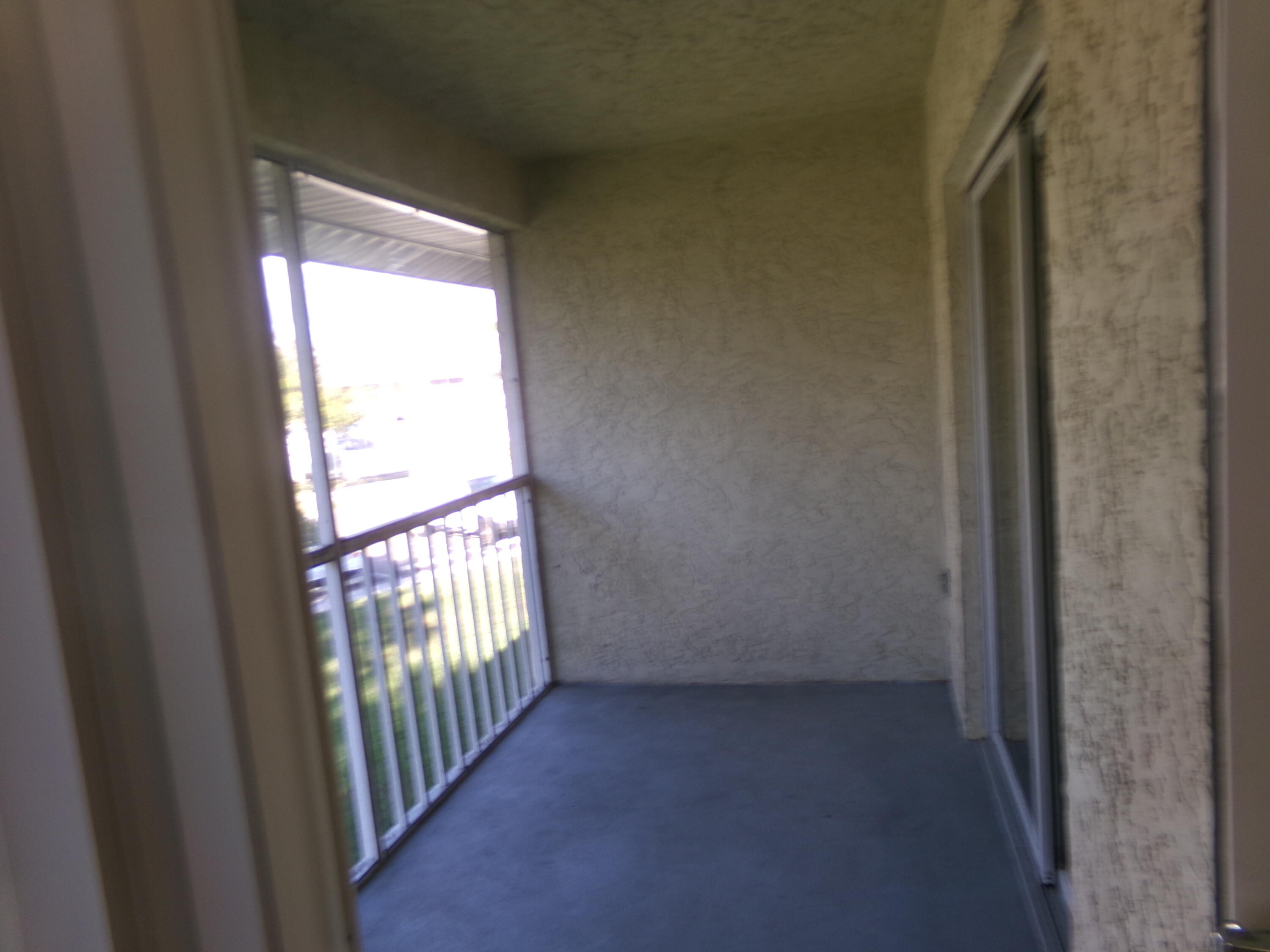 1514 Southeast Royal Green Circle, Unit I203 Port St. Lucie, FL 34952 - Photo 13 of 13 a view of an empty room and a window