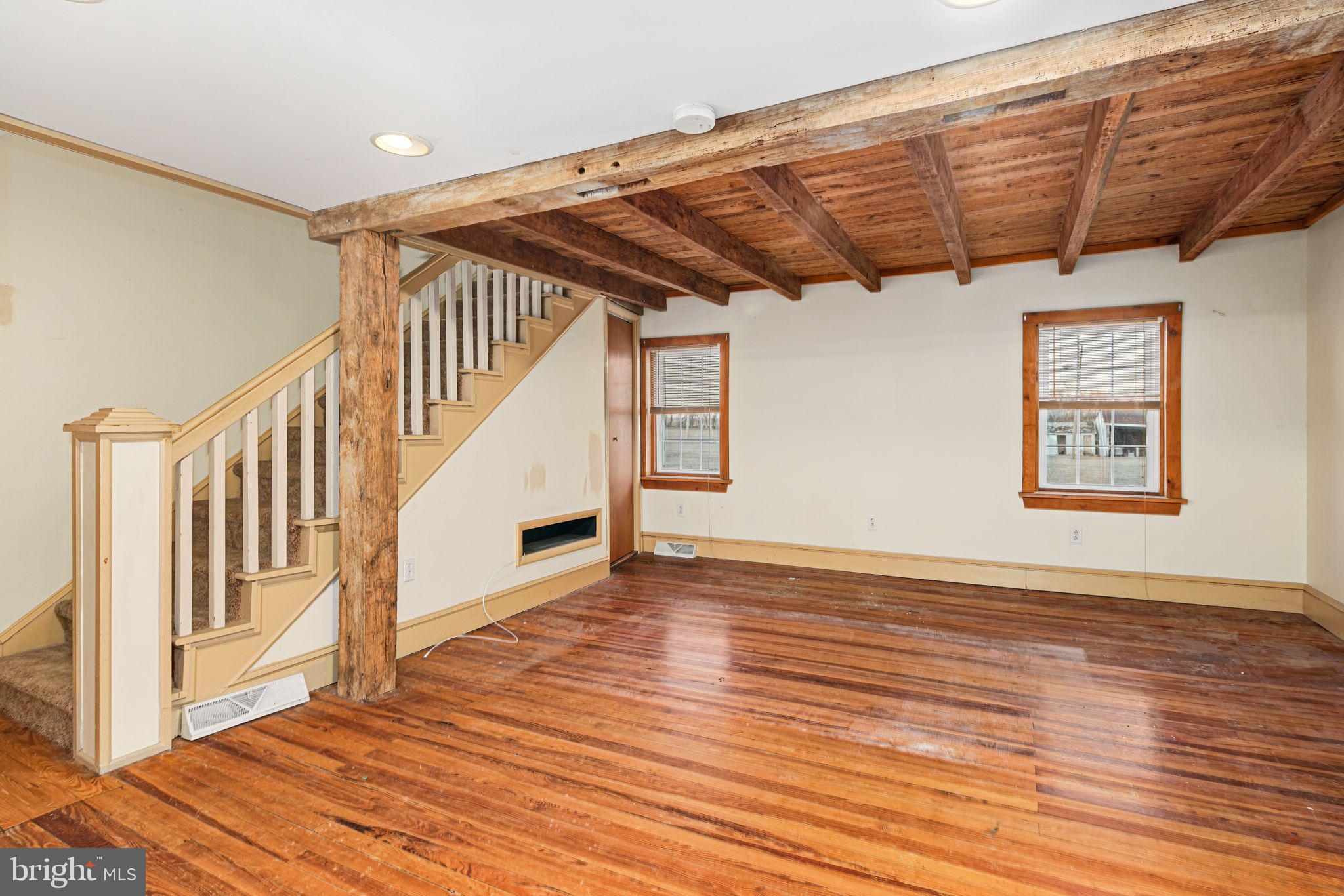 39 Main Street Pilesgrove, NJ 08098 - Photo 9 of 30 a view of an empty room with wooden floor and stairs
