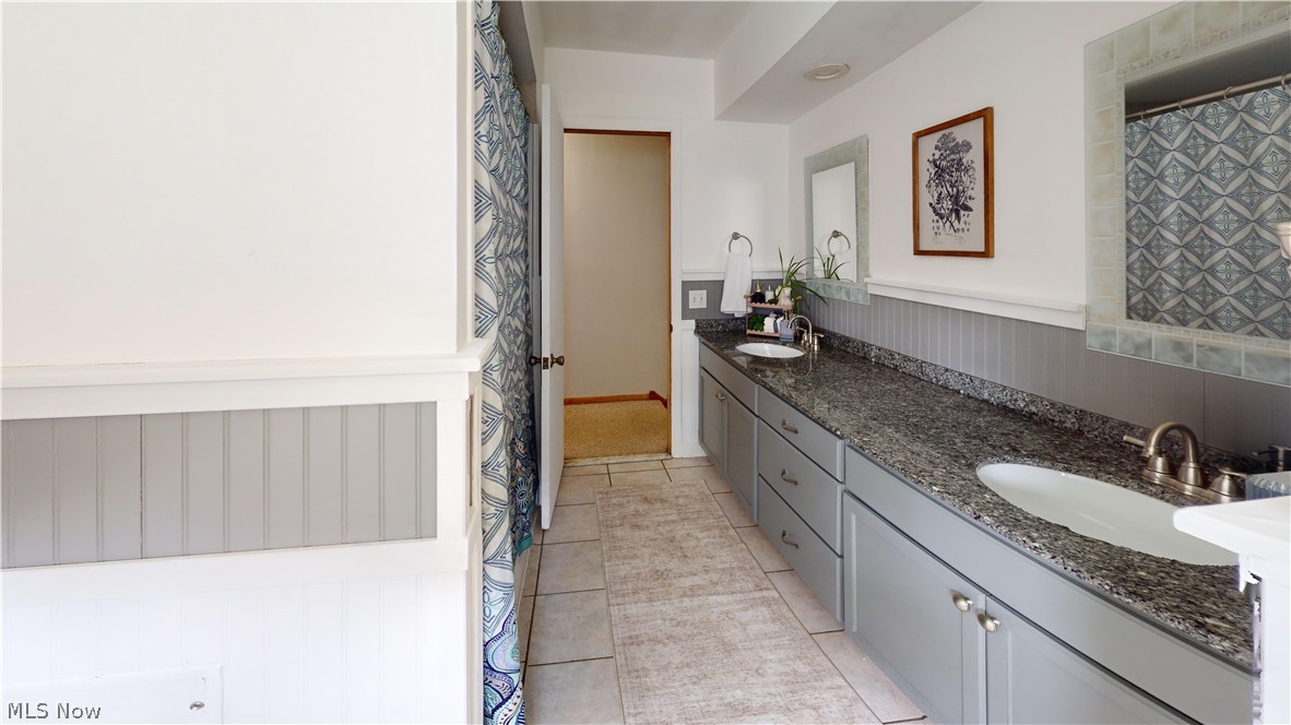 9260 Avery Road Broadview Heights, OH 44147 - Photo 25 of 43 Double vanity with gray cabinetry, granite-style countertop, and dual undermount sinks