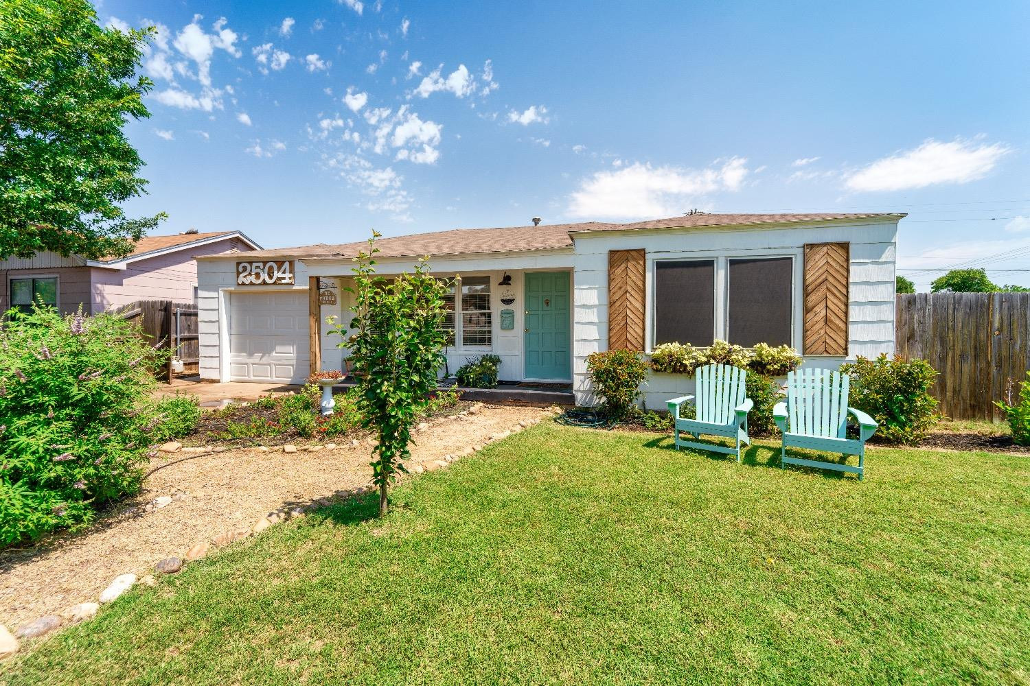 a view of a house with backyard porch and sitting area