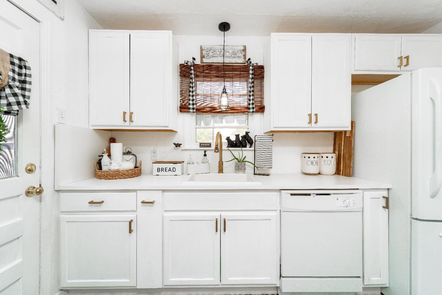 2504 42nd Street Lubbock, TX 79413 - Photo 12 of 24 a kitchen with white cabinets and white appliances