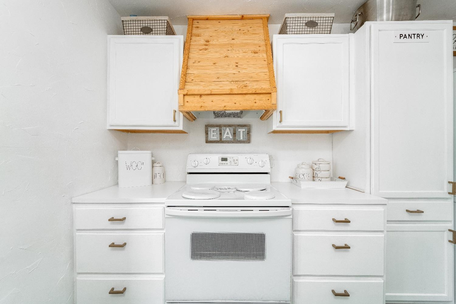 2504 42nd Street Lubbock, TX 79413 - Photo 10 of 24 a kitchen with a white cabinets and white appliances