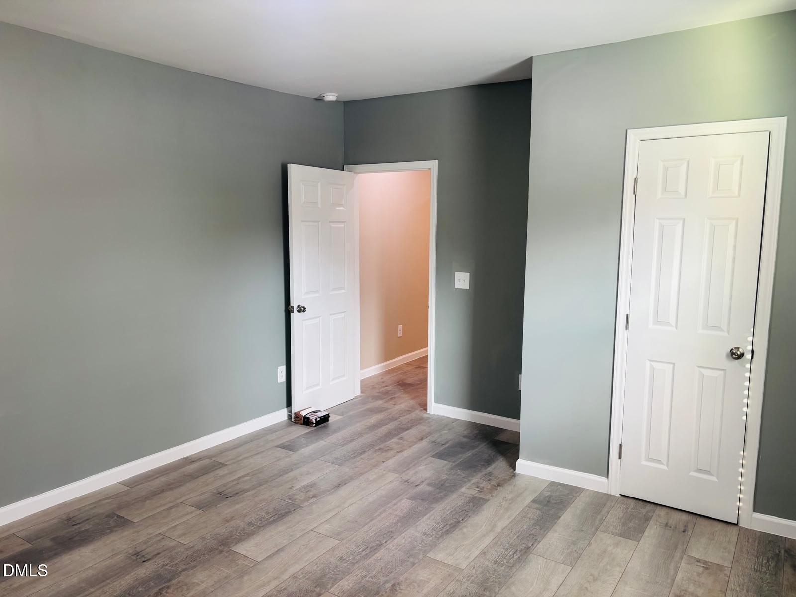 5408 Spence Farm Road, Unit B Holly Springs, NC 27540 - Photo 14 of 19 an empty room with wooden floor and entrance