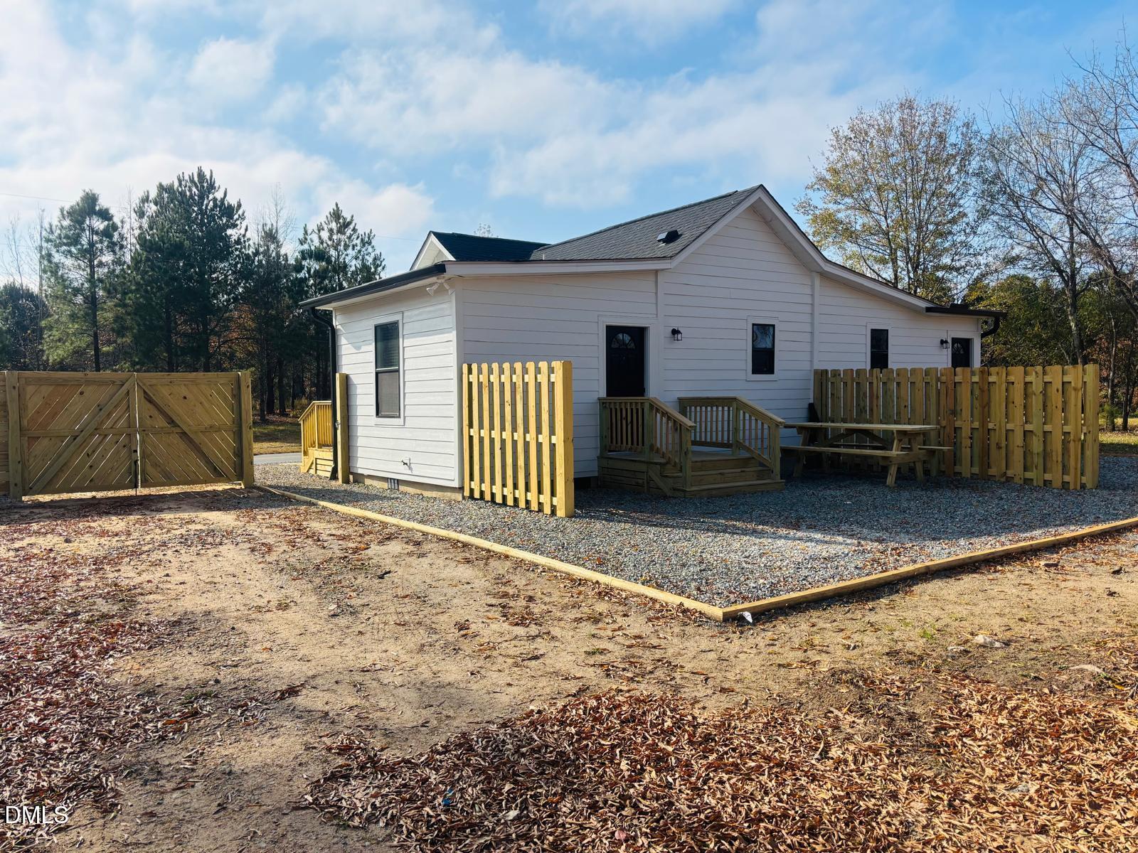 5408 Spence Farm Road, Unit B Holly Springs, NC 27540 - Photo 16 of 19 a view of a house with a yard and wooden fence