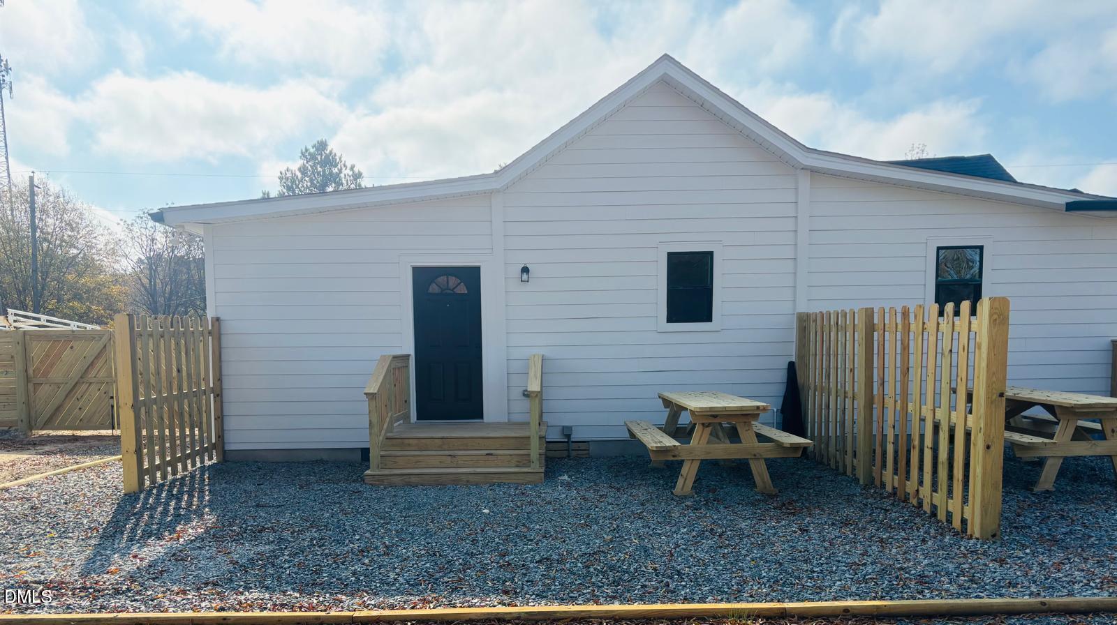 5408 Spence Farm Road, Unit B Holly Springs, NC 27540 - Photo 18 of 19 a backyard of a house with barbeque oven table and chairs