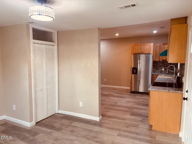 a view of a kitchen with a sink and refrigerator