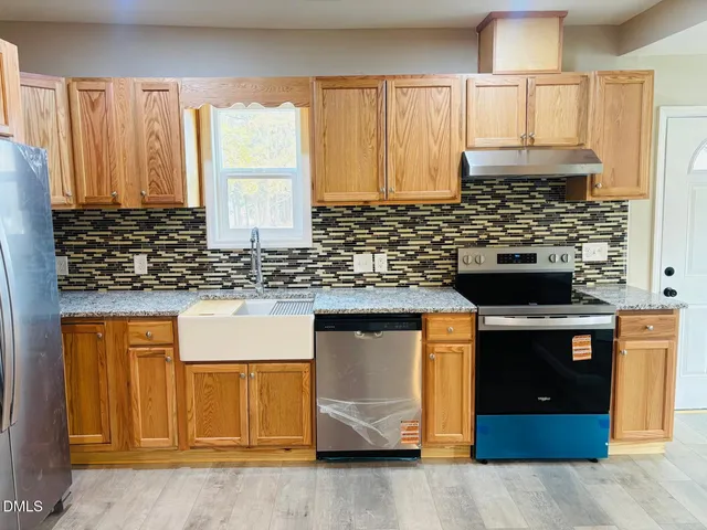 a view of kitchen with granite countertop window
