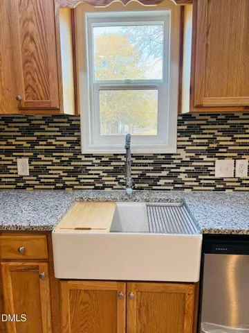 a kitchen with stainless steel appliances granite countertop a refrigerator and a stove