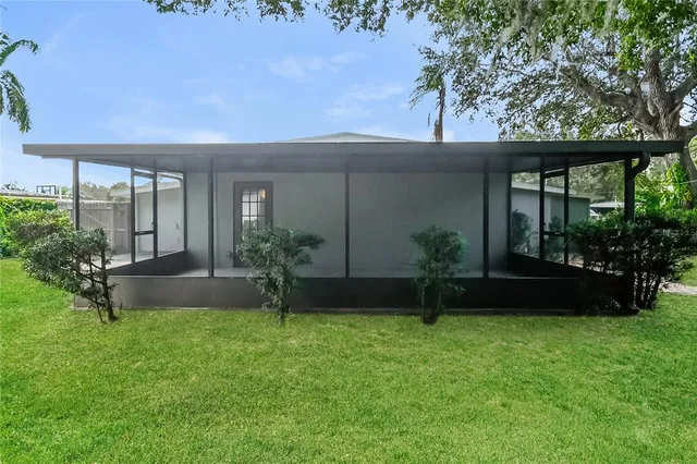 a view of house with backyard and a garden