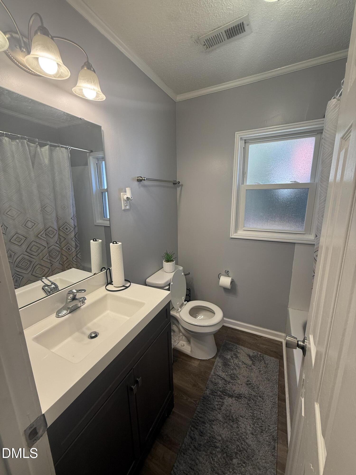 3792 McNeill Hobbs Road Bunnlevel, NC 28323 - Photo 14 of 14 a bathroom with a sink mirror and toilet