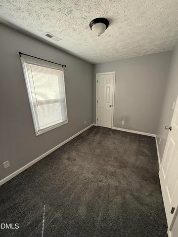 an empty room with a empty space and windows