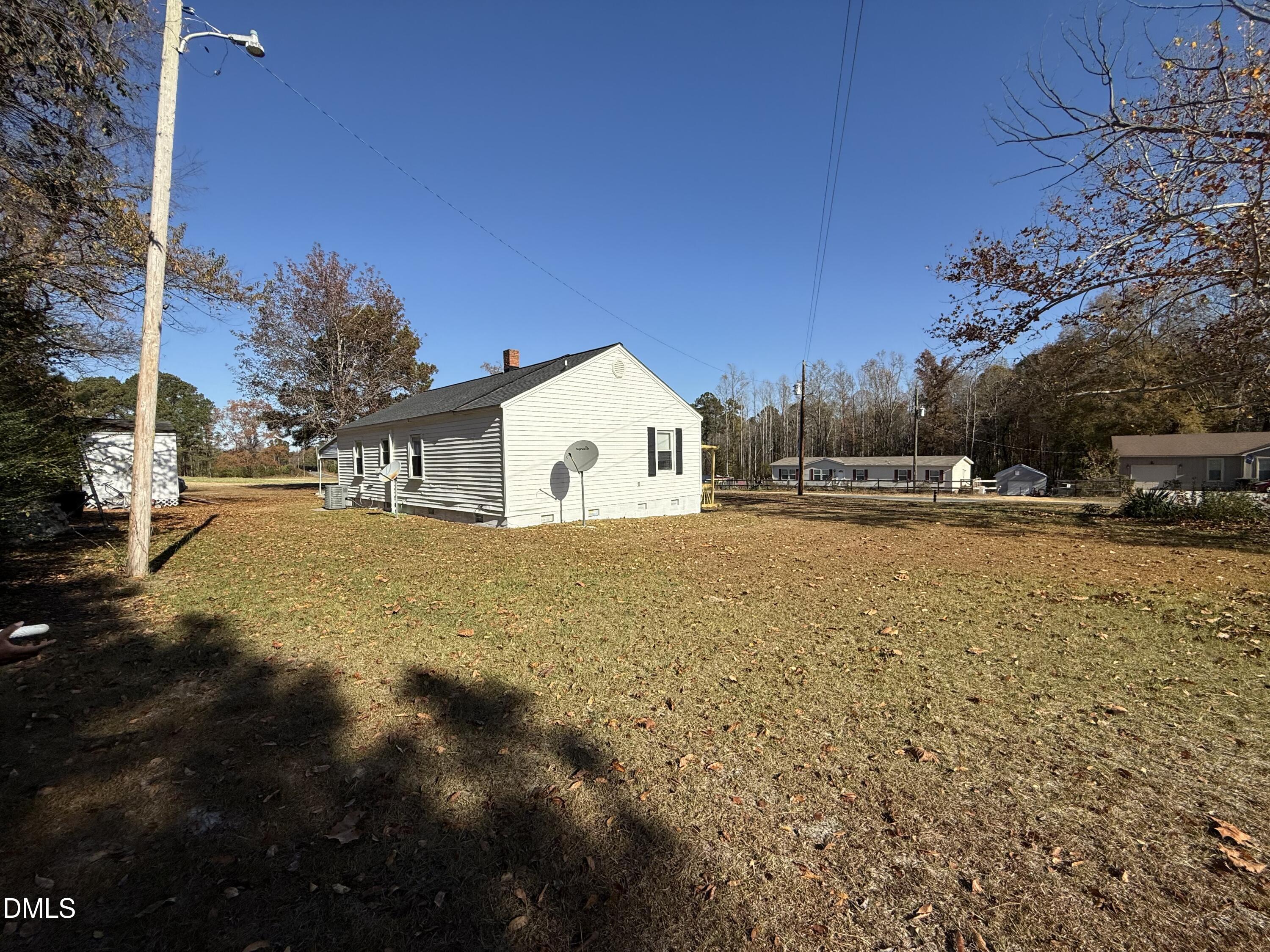 3792 McNeill Hobbs Road Bunnlevel, NC 28323 - Photo 5 of 14 a view of white house with a yard