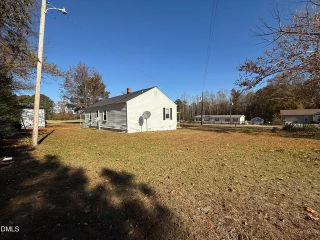 a view of white house with a yard