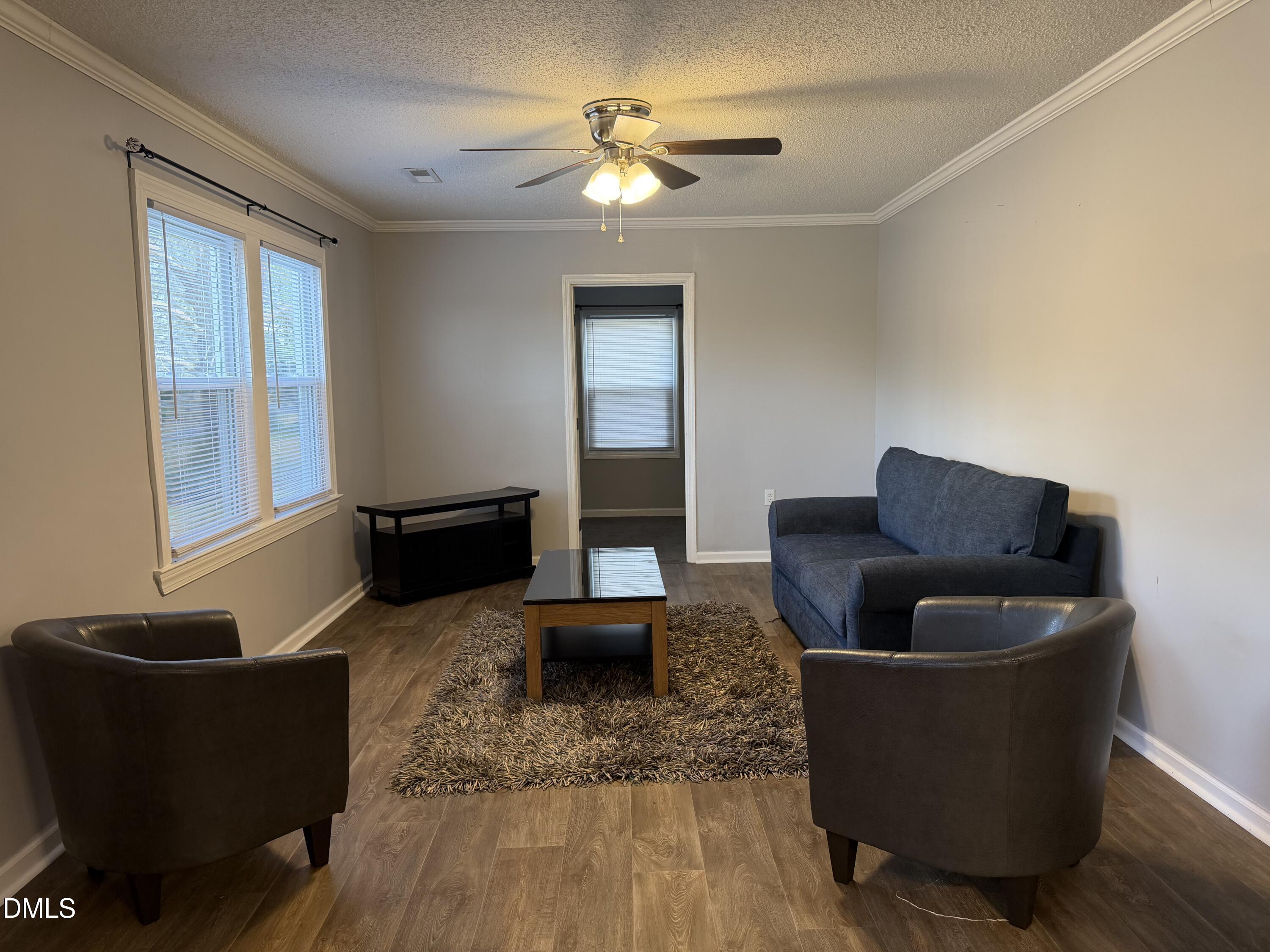 3792 McNeill Hobbs Road Bunnlevel, NC 28323 - Photo 8 of 12 a living room with furniture and a lamp