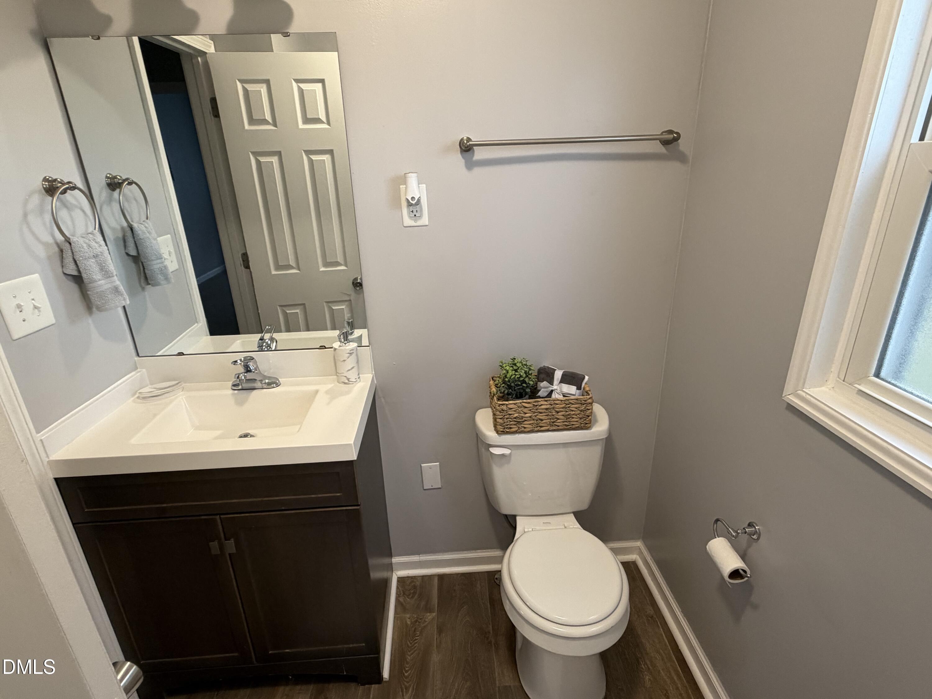 3792 McNeill Hobbs Road Bunnlevel, NC 28323 - Photo 9 of 12 a bathroom with a toilet sink and mirror