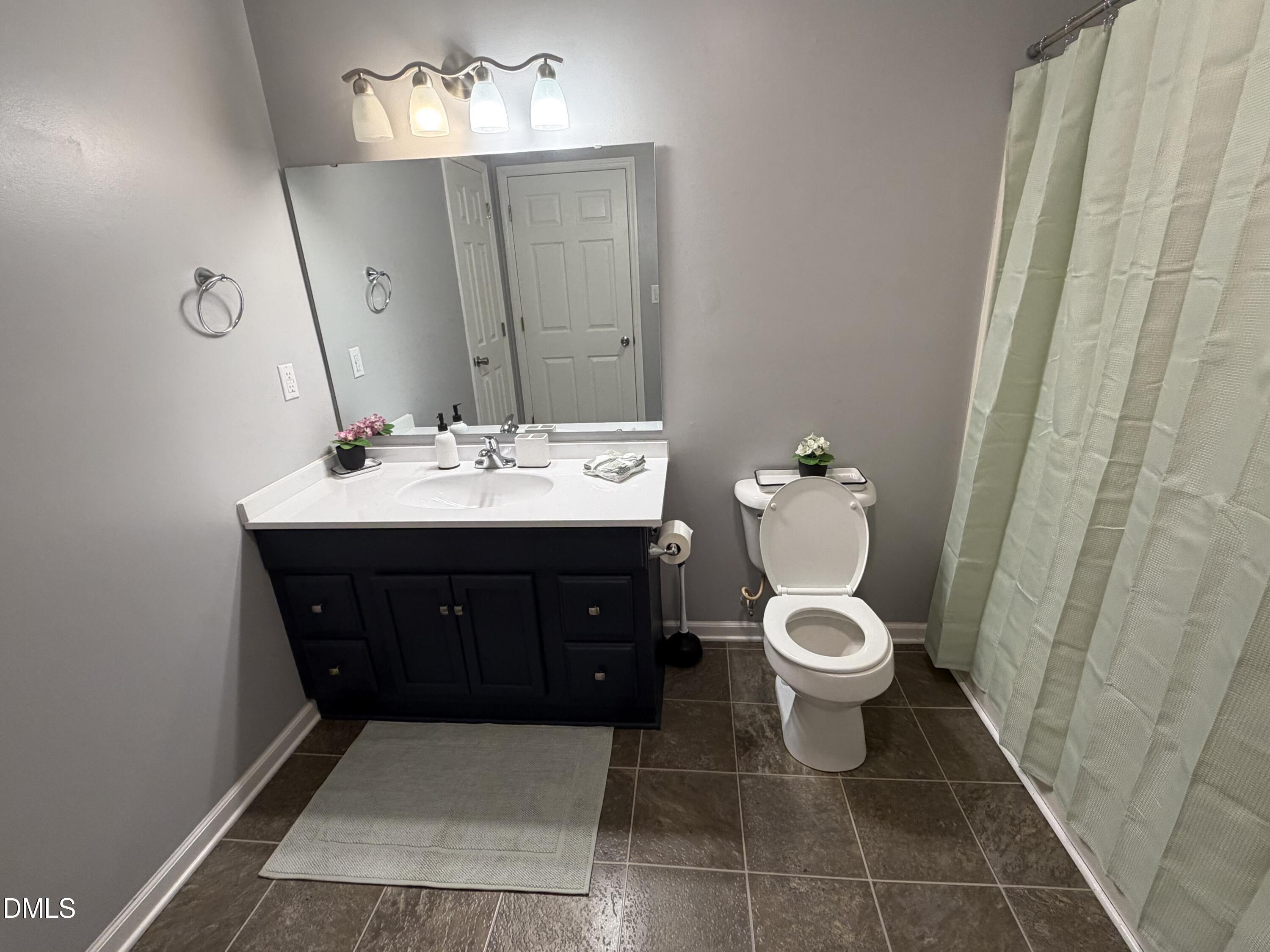 3792 McNeill Hobbs Road Bunnlevel, NC 28323 - Photo 10 of 12 a bathroom with a toilet sink and mirror