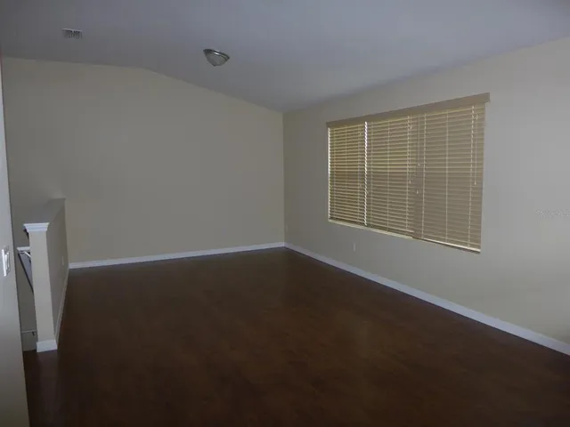 a view of an empty room with a window