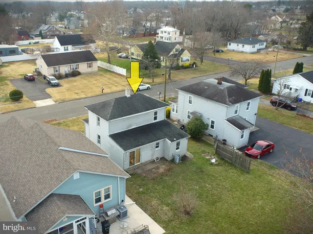 an aerial view of a house with a swimming pool