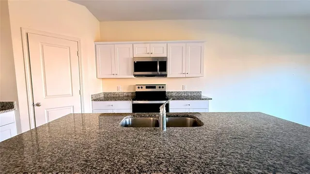 a kitchen with a stove and a white refrigerator