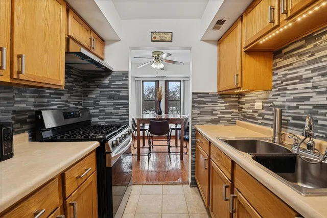 a kitchen with a sink cabinets and black stainless steel appliances