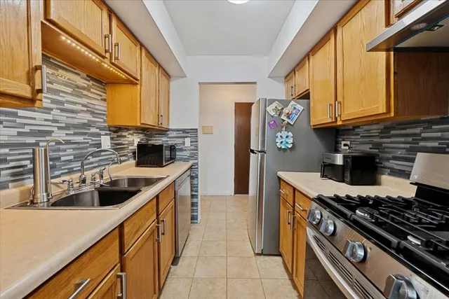 a kitchen with stainless steel appliances granite countertop a stove and a sink