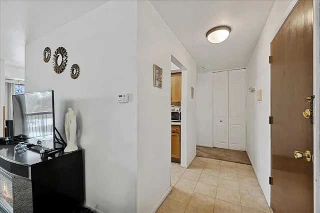 a view of a hallway with workspace and mirror