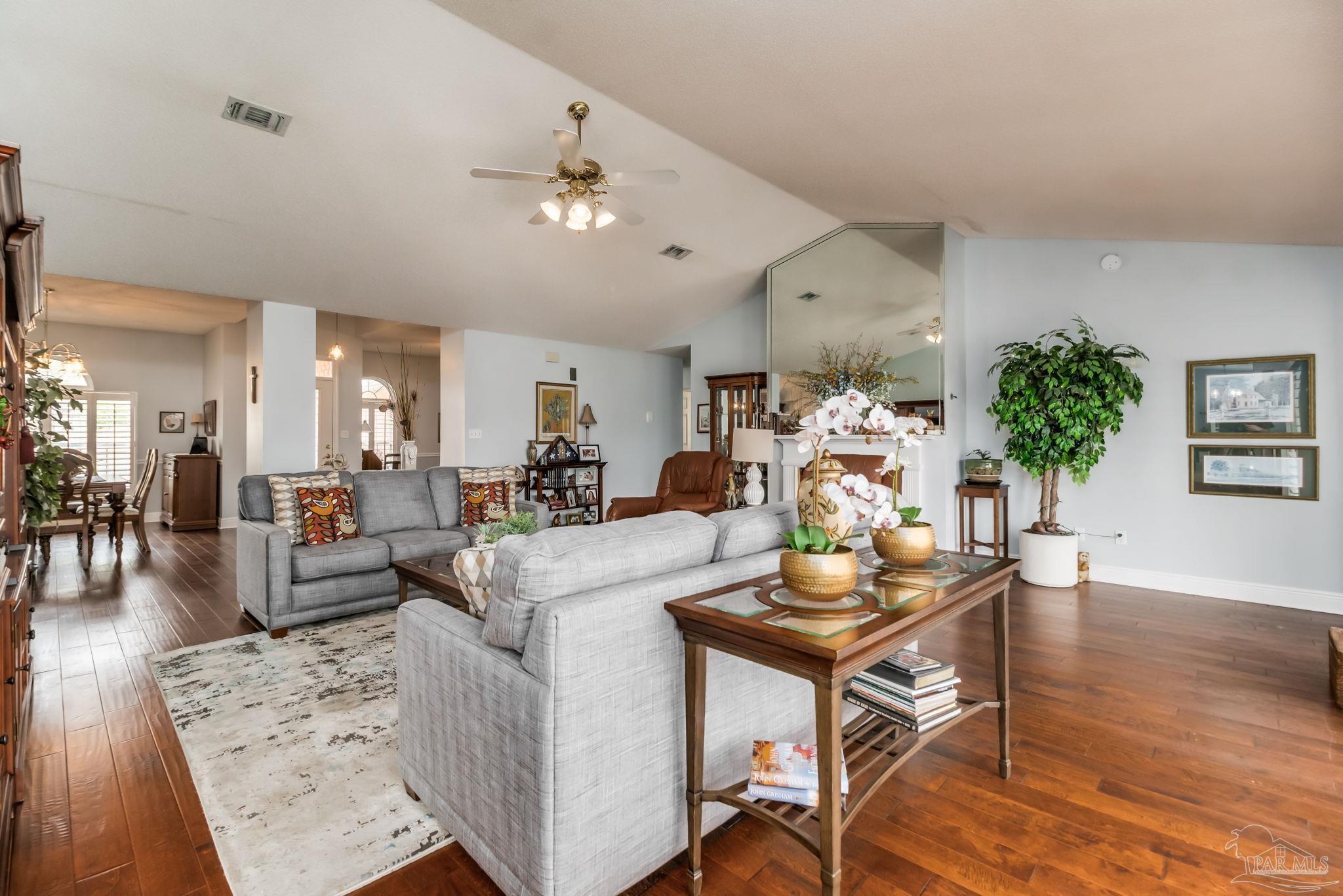 3106 Cobblestone Drive Pace, FL 32571 - Photo 11 of 61 a living room with furniture kitchen view and a chandelier