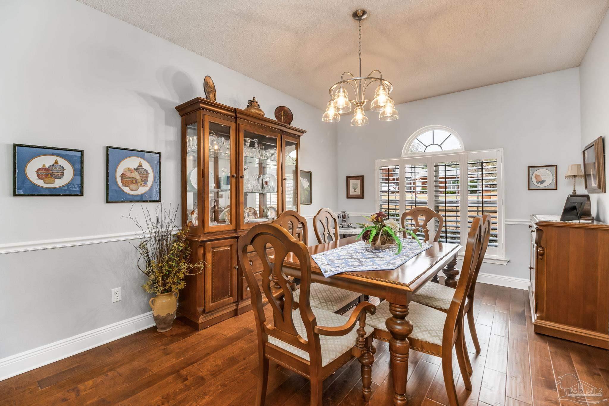3106 Cobblestone Drive Pace, FL 32571 - Photo 13 of 61 a view of a dining room with furniture window and wooden floor