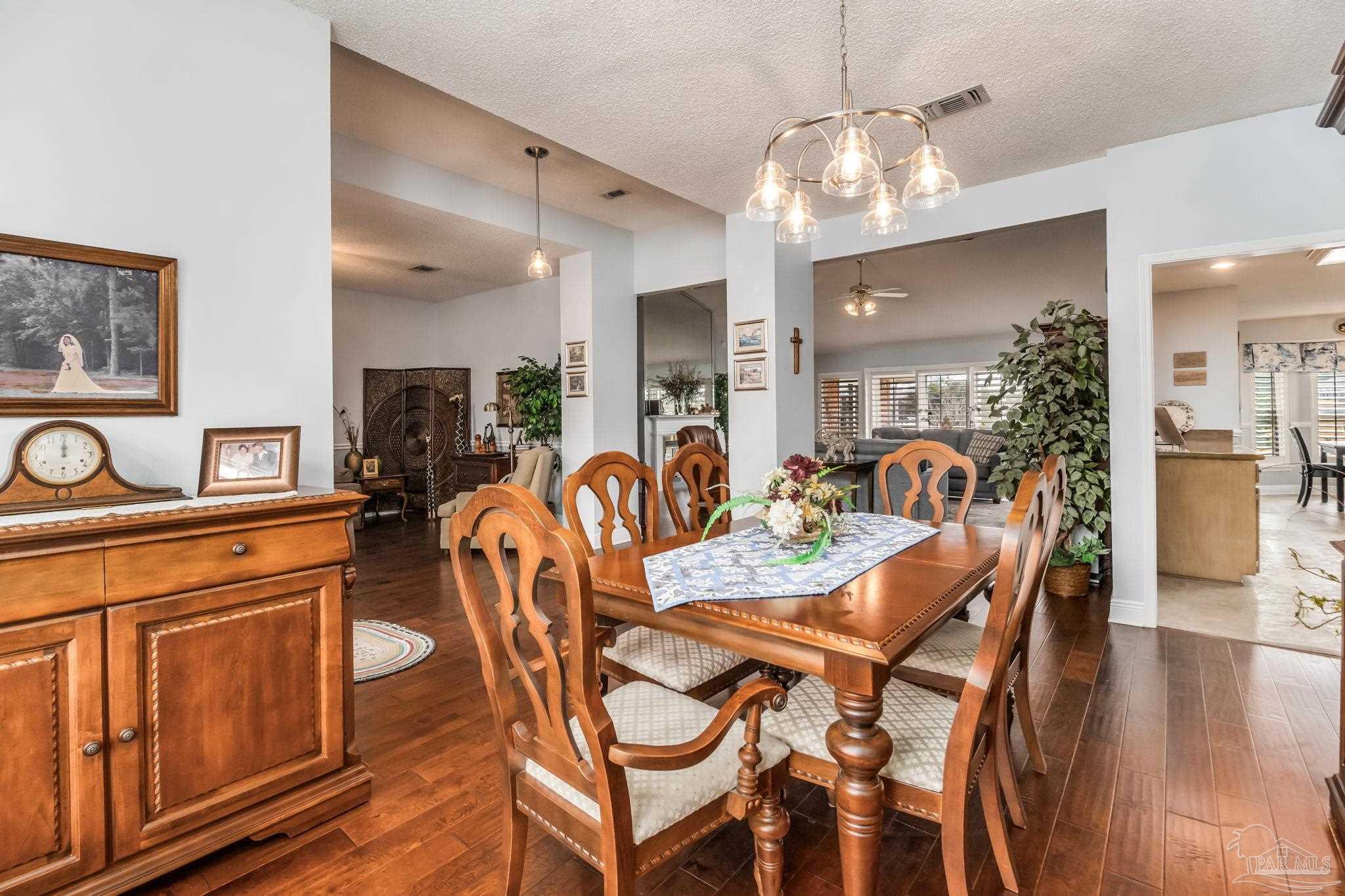 3106 Cobblestone Drive Pace, FL 32571 - Photo 18 of 61 a view of a dining room with furniture and wooden floor