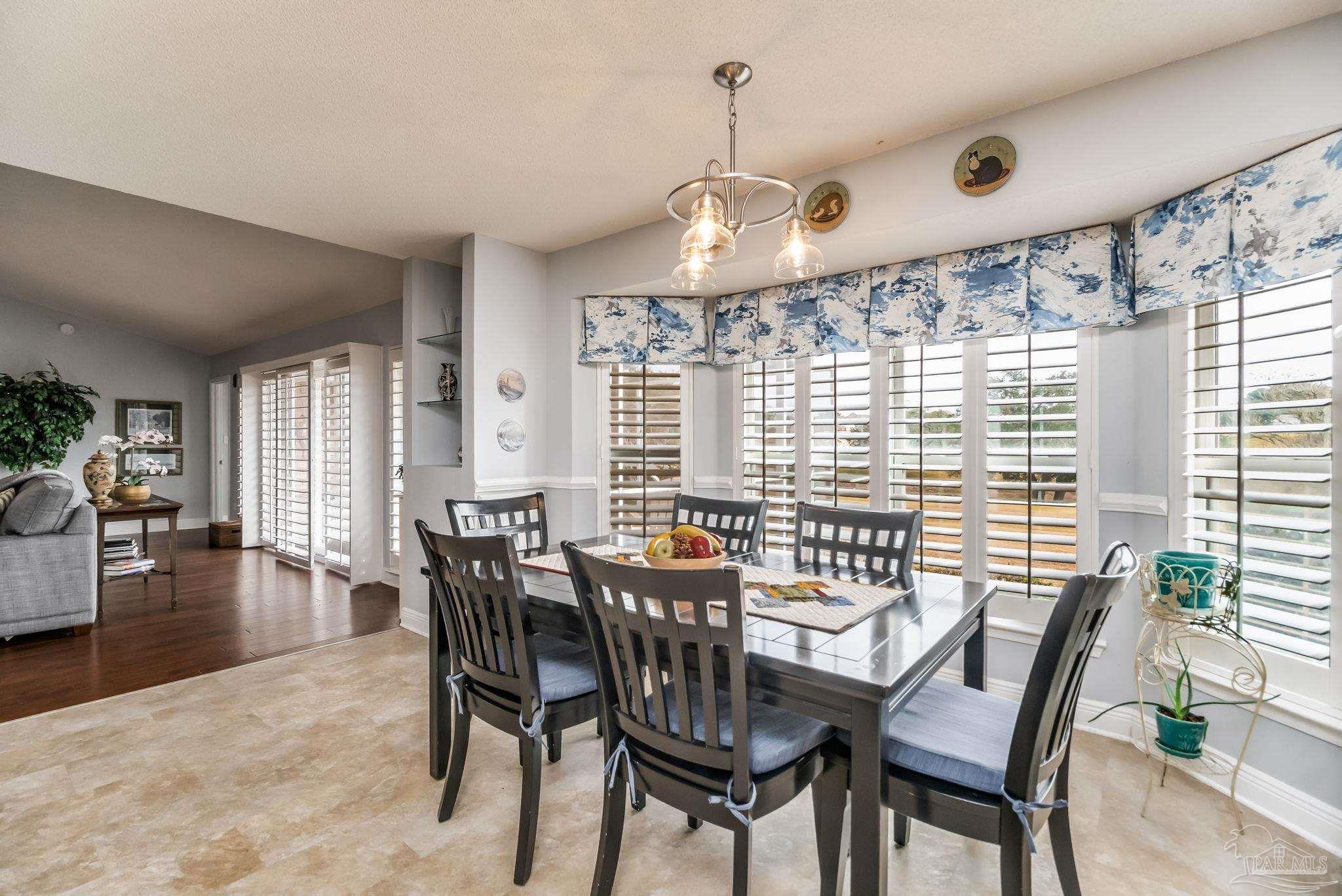 3106 Cobblestone Drive Pace, FL 32571 - Photo 21 of 61 a view of a dining room with furniture window and wooden floor