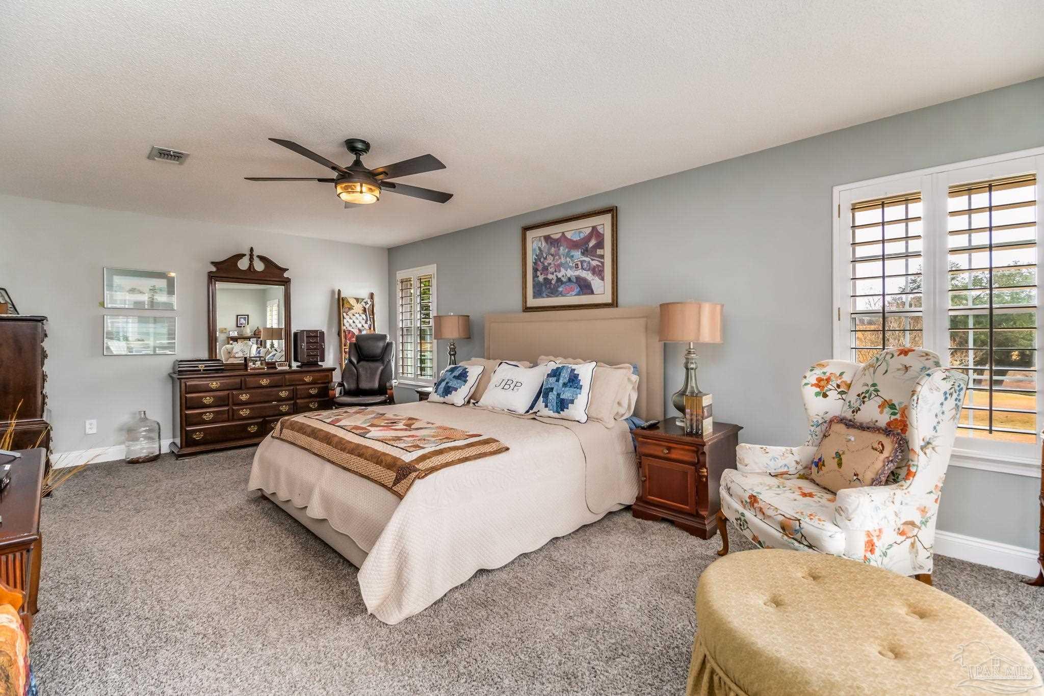 3106 Cobblestone Drive Pace, FL 32571 - Photo 25 of 61 a spacious bedroom with a bed and ceiling fan