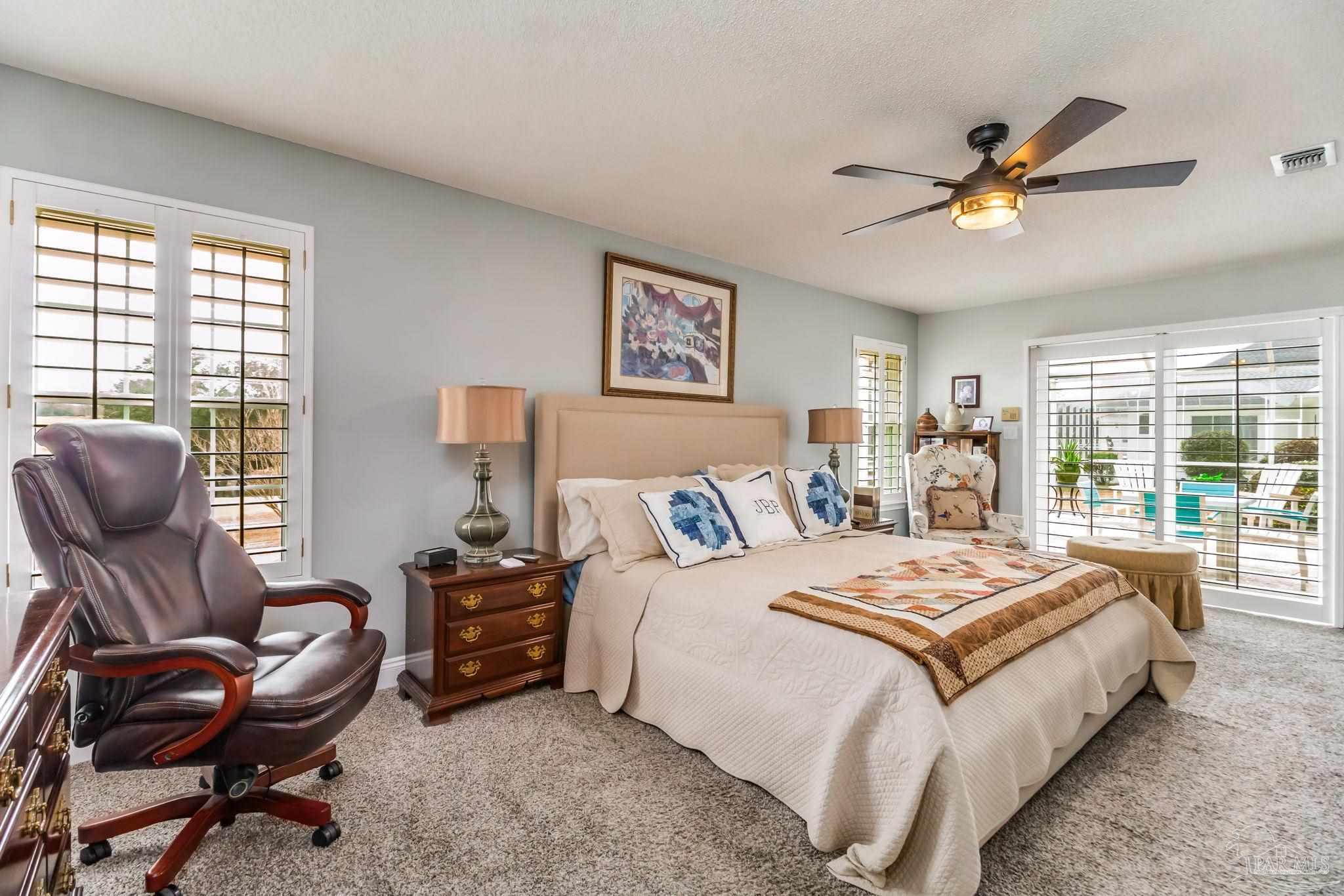 3106 Cobblestone Drive Pace, FL 32571 - Photo 26 of 61 a bedroom with a bed and a chair