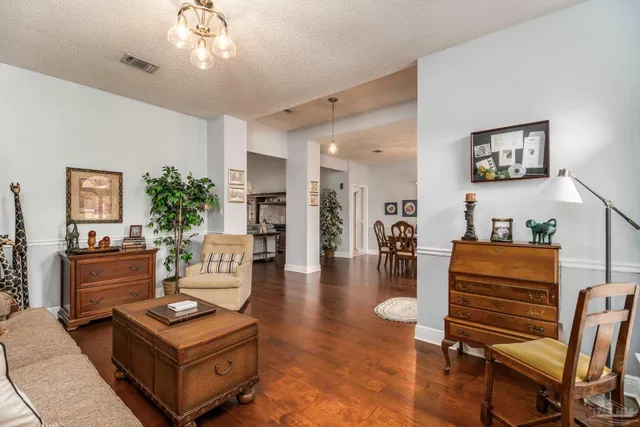 a living room with furniture and a chandelier