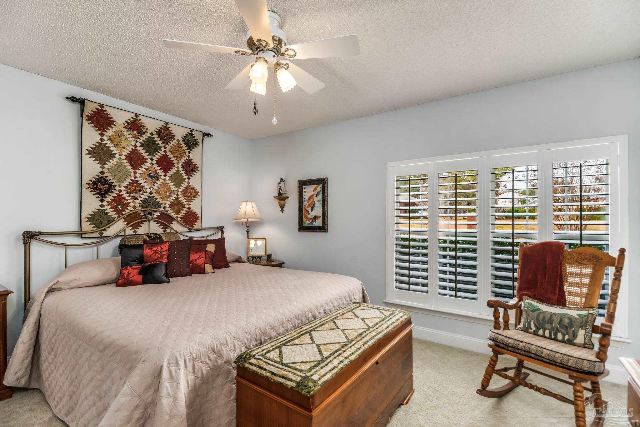 3106 Cobblestone Drive Pace, FL 32571 - Photo 31 of 61 a bedroom with a bed and a chandelier